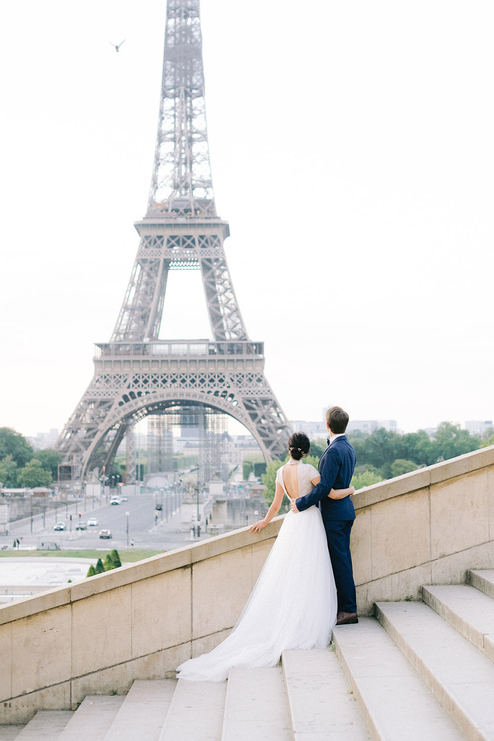 the couple look the eiffel tower